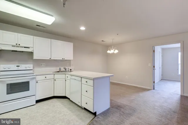 a kitchen that has a sink and a stove in it