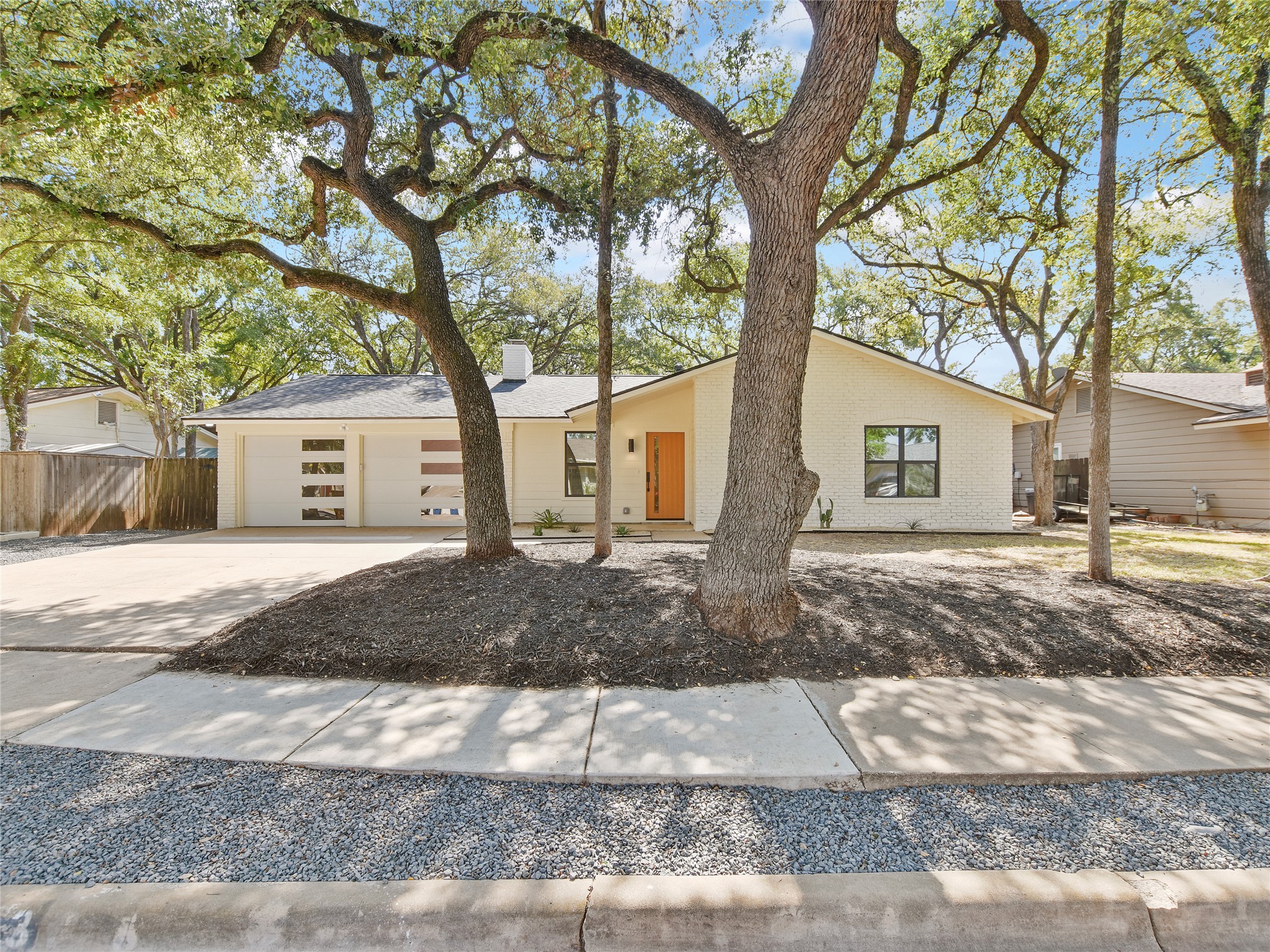 5903 Gateshead Drive Austin, TX 78745 - Photo 1 of 26 a front view of a house with a yard and trees