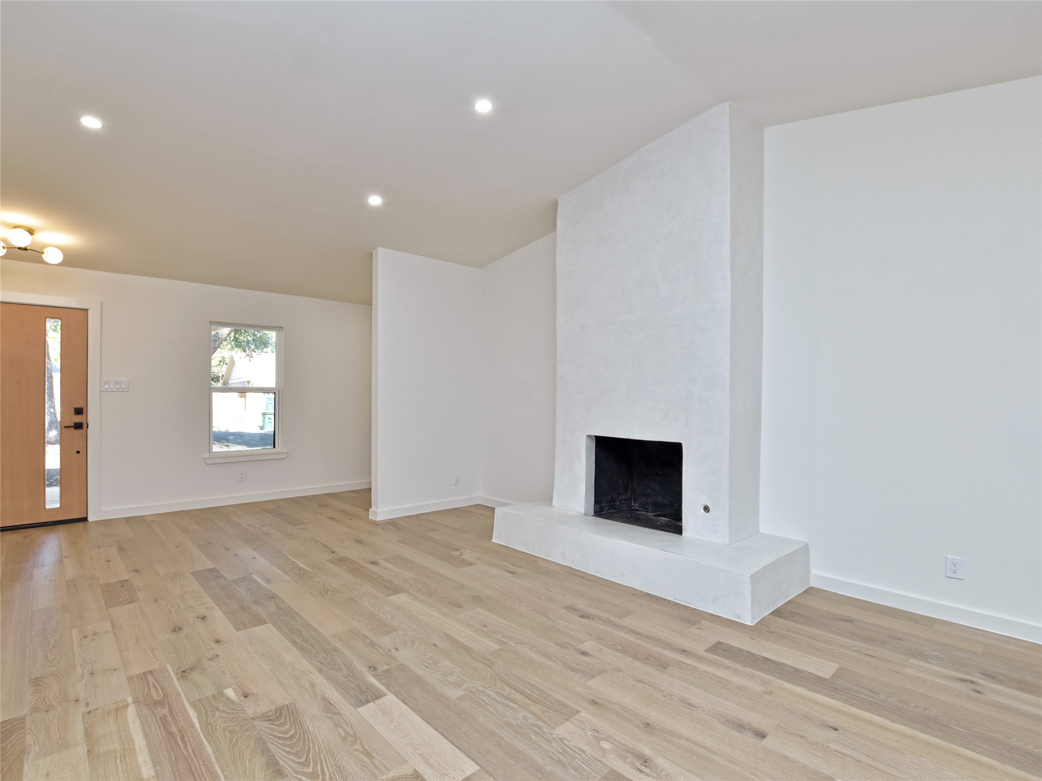 5903 Gateshead Drive Austin, TX 78745 - Photo 12 of 26 a view of empty room with wooden floor and fireplace