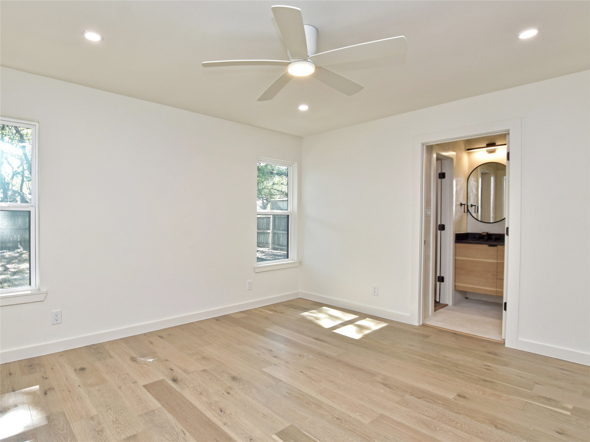 5903 Gateshead Drive Austin, TX 78745 - Photo 13 of 26 an empty room with wooden floor cabinet and windows