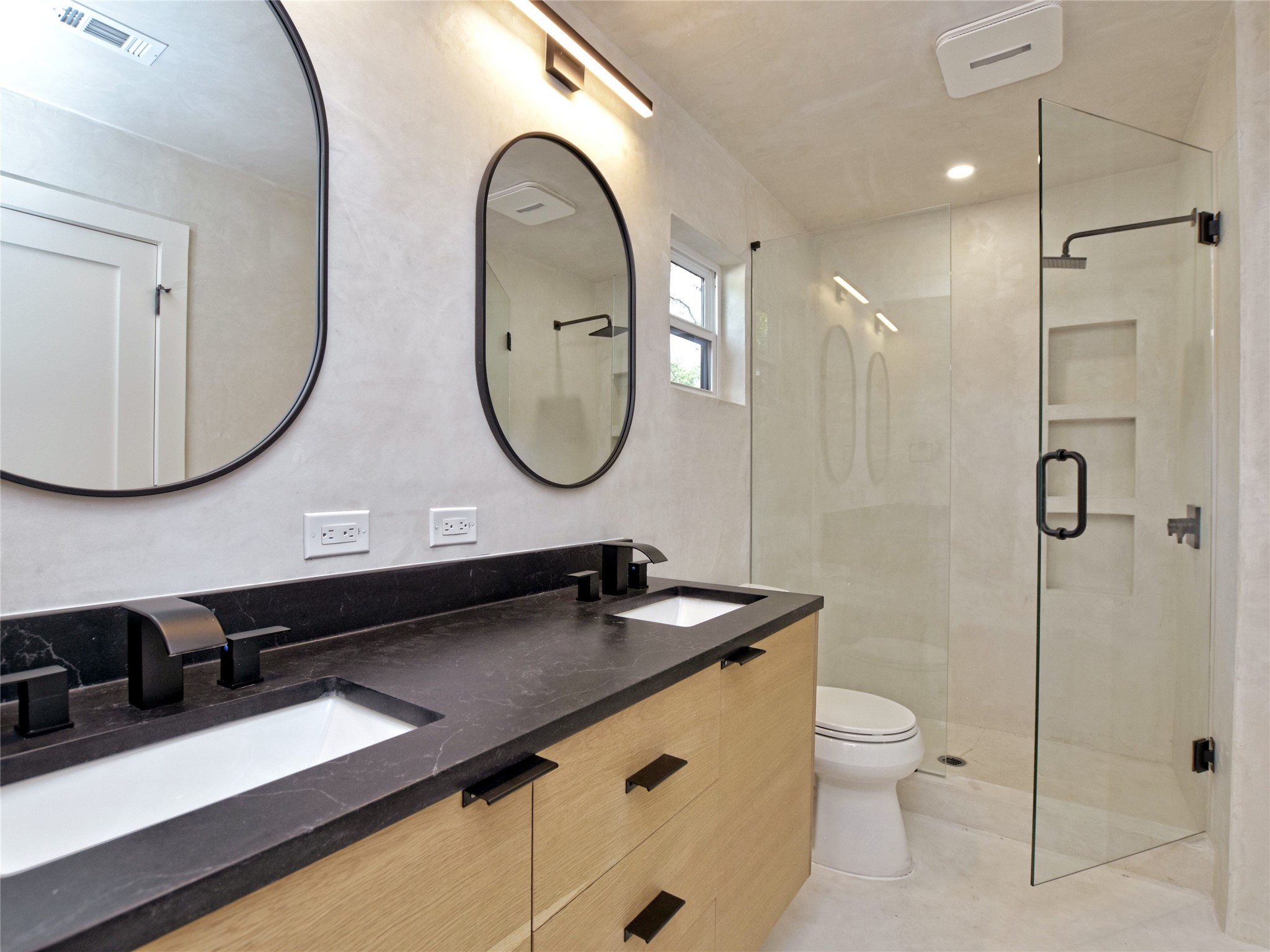 5903 Gateshead Drive Austin, TX 78745 - Photo 15 of 26 a bathroom with a sink a toilet and a mirror