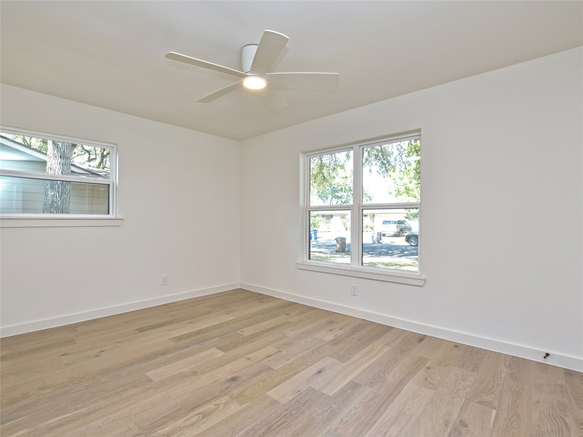 5903 Gateshead Drive Austin, TX 78745 - Photo 17 of 26 an empty room with wooden floor and windows