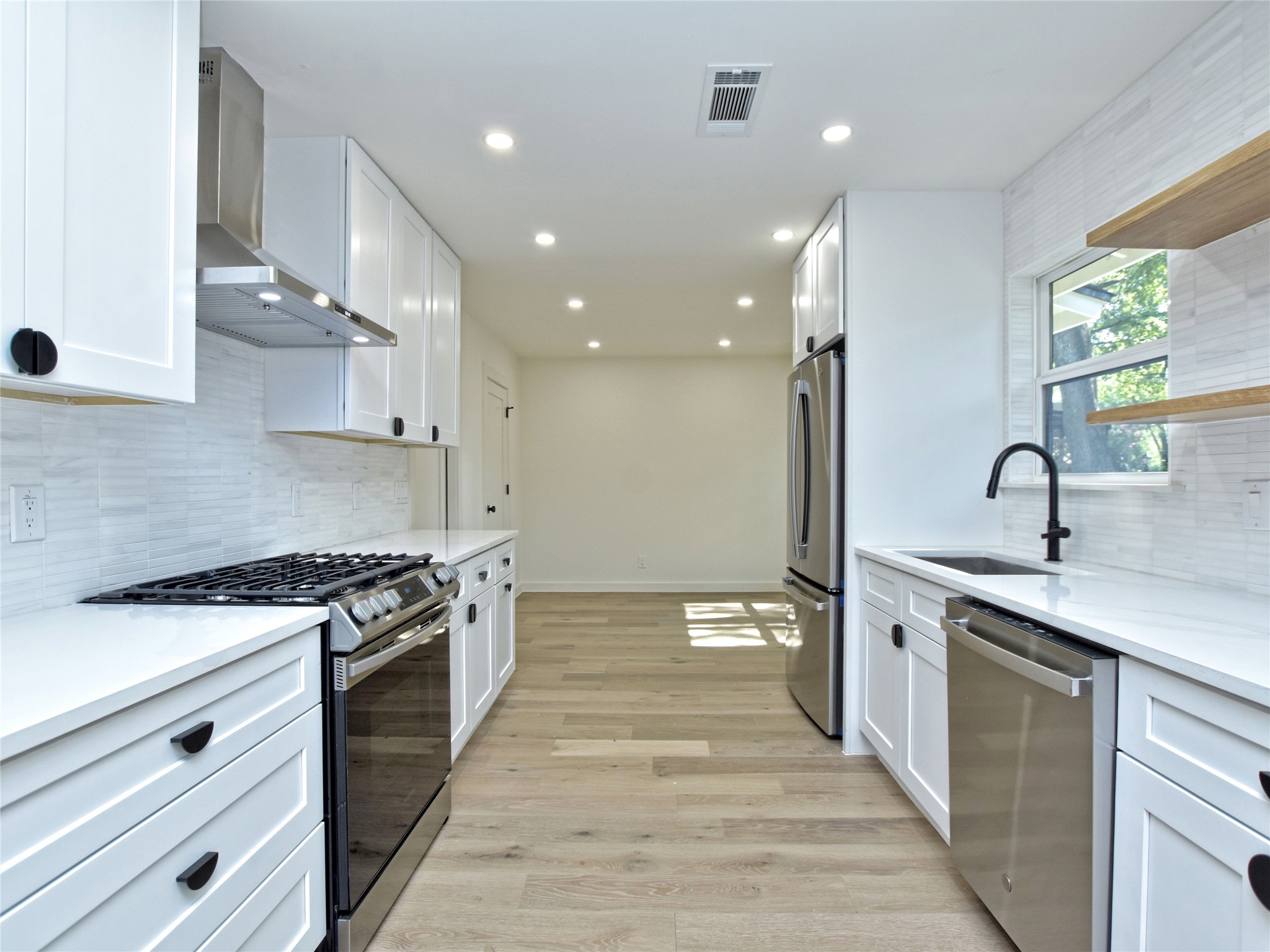 5903 Gateshead Drive Austin, TX 78745 - Photo 7 of 26 a kitchen with stainless steel appliances granite countertop a stove and a sink