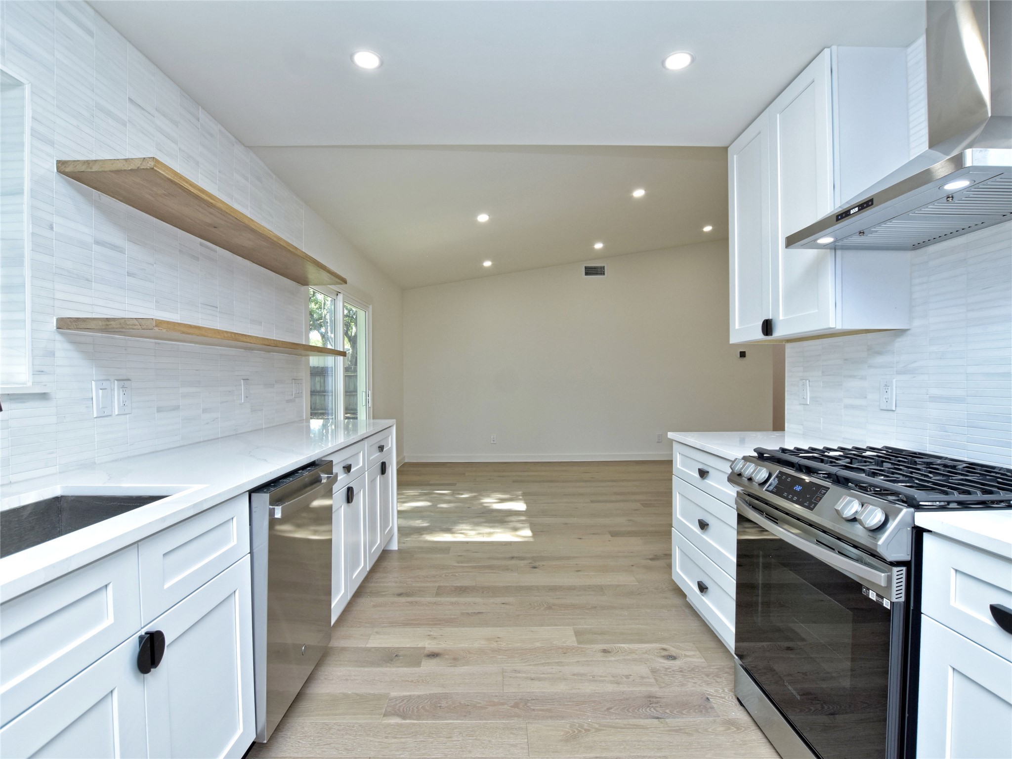 5903 Gateshead Drive Austin, TX 78745 - Photo 8 of 26 a kitchen with stainless steel appliances a stove and a sink