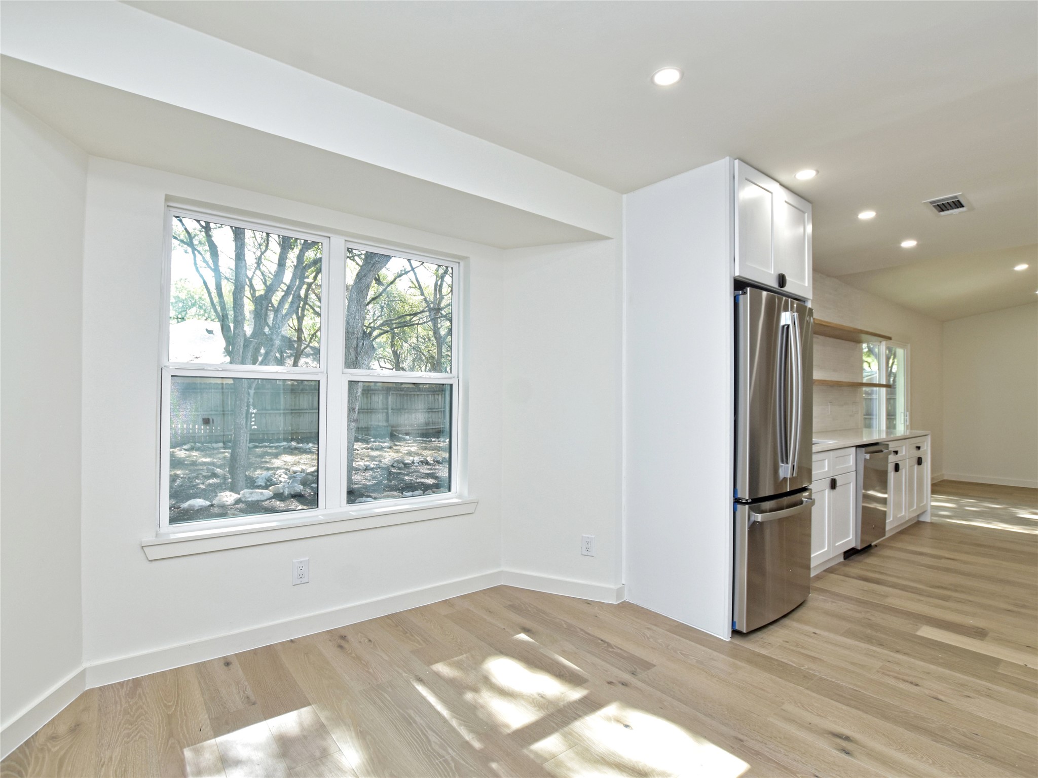 5903 Gateshead Drive Austin, TX 78745 - Photo 9 of 26 a view of a kitchen with a refrigerator cabinets and wooden floor