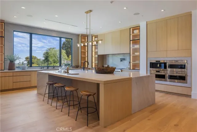 a kitchen with stainless steel appliances kitchen island a large island in the center