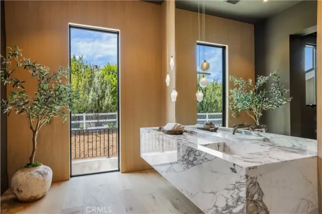 a view of a livingroom with furniture and floor to ceiling window