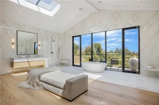 a spacious bedroom with a large bed and a large window