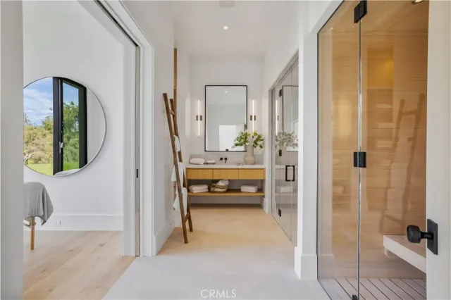 a bedroom with bed and a large window with balcony view
