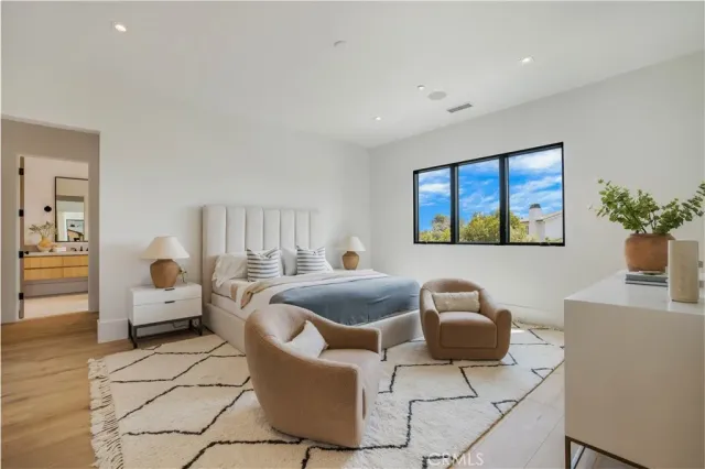 a bathroom with a double vanity sink toilet mirror and bathtub