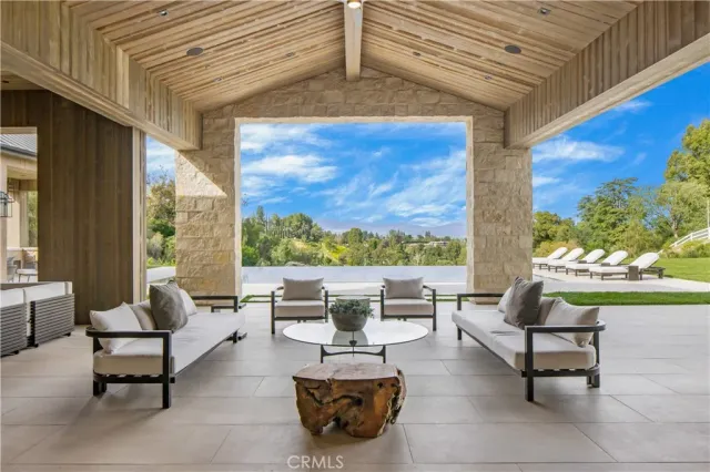 an outdoor sitting area with a lake view