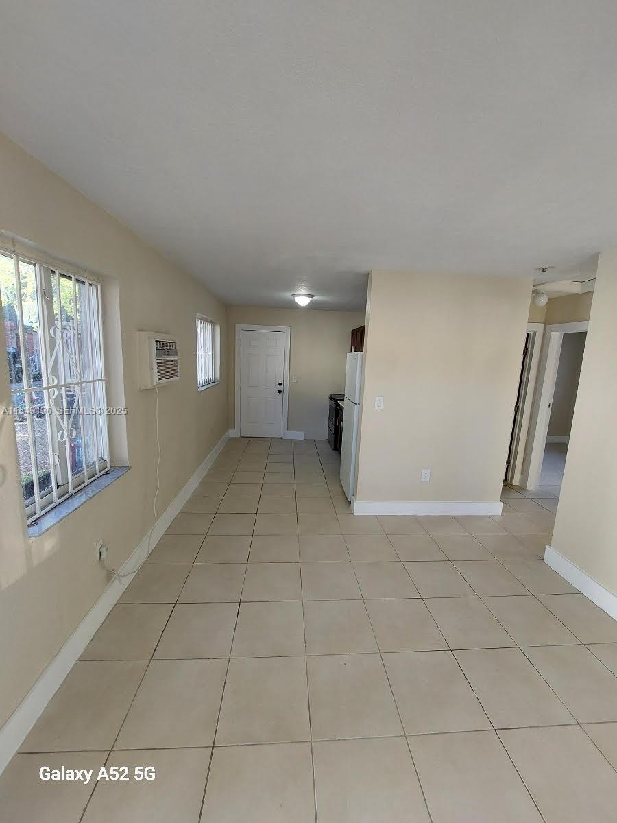 1574 Northwest 58th Street Miami, FL 33142 - Photo 4 of 11 a view of an empty room with a window
