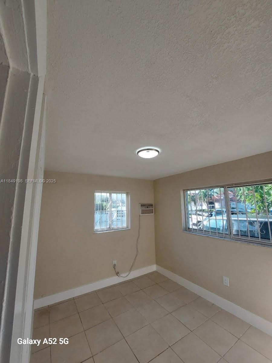 1574 Northwest 58th Street Miami, FL 33142 - Photo 10 of 11 a view of an empty room and window
