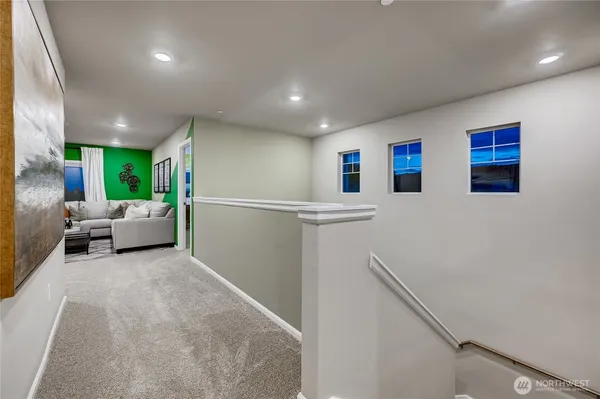 a living room with stainless steel appliances with kitchen island