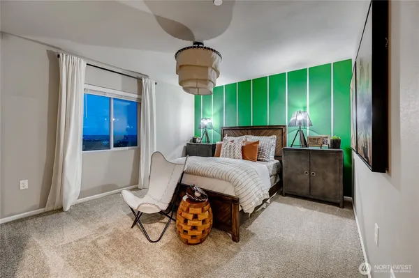 a bedroom with furniture and a large window