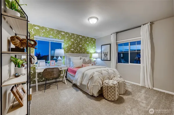 a spacious bedroom with a bed and a window