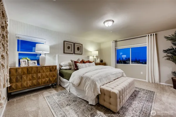 a bedroom with a large bed and a couch