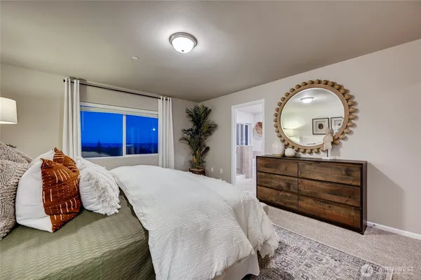 a bedroom with a bed and a mirror