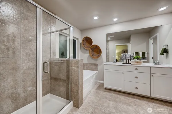 a spacious bathroom with a double vanity sink and a mirror