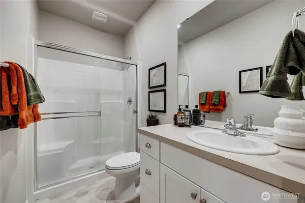 a bathroom with a sink toilet and shower