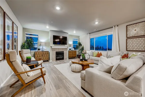 a living room with furniture a fireplace and a flat screen tv