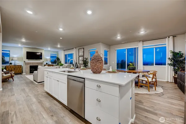 a kitchen with white cabinets and sink