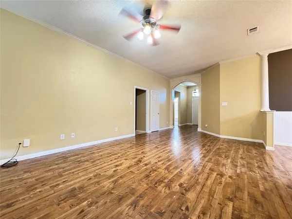 a view of a livingroom with a chandelier fan and a workspace
