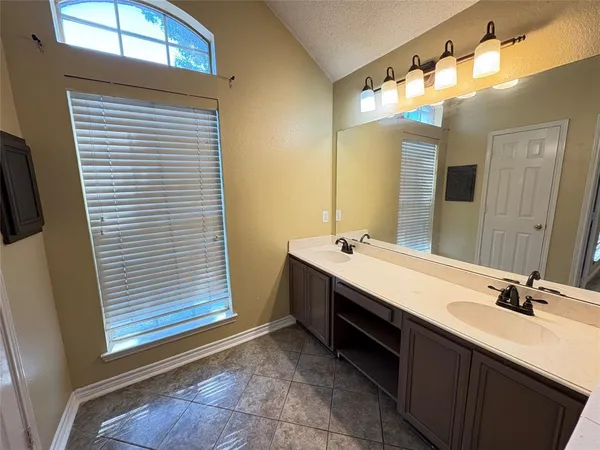 a bathroom with a double vanity sink and a mirror