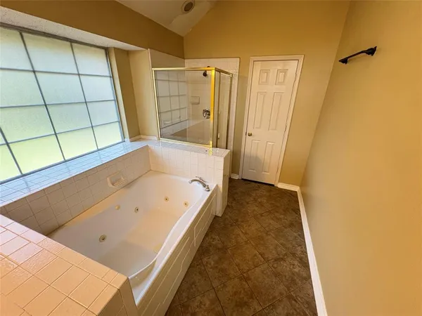 a bathroom with a tub a sink and a shower