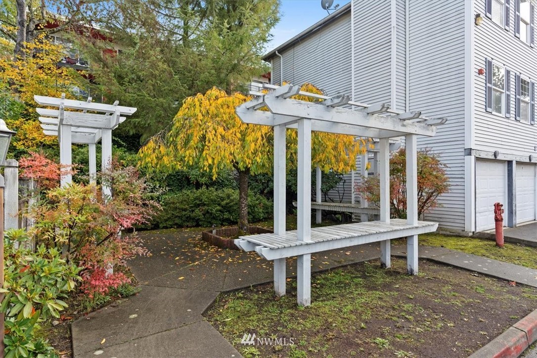 1160 Monroe Avenue Northeast, Unit B1 Renton, WA 98056 - Photo 2 of 24 a view of a chair and table in backyard of the house