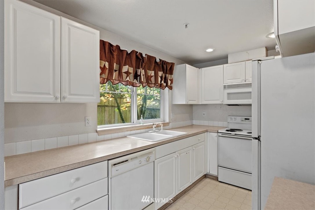 1160 Monroe Avenue Northeast, Unit B1 Renton, WA 98056 - Photo 18 of 24 a kitchen with a sink and cabinets