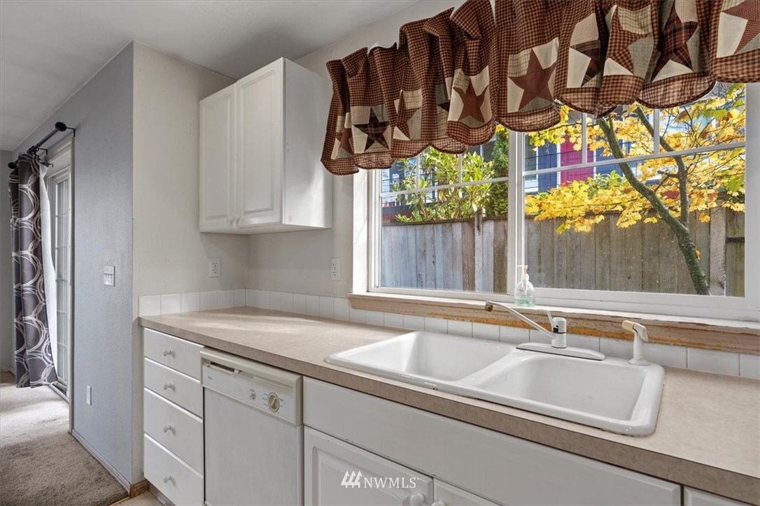 1160 Monroe Avenue Northeast, Unit B1 Renton, WA 98056 - Photo 20 of 24 a kitchen with a sink and cabinets
