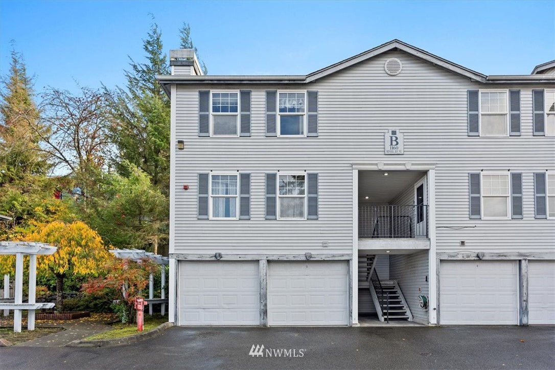 1160 Monroe Avenue Northeast, Unit B1 Renton, WA 98056 - Photo 3 of 24 a front view of a house with a garage