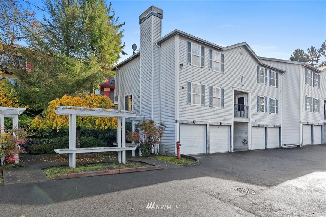 1160 Monroe Avenue Northeast, Unit B1 Renton, WA 98056 - Photo 5 of 24 a view of a white house with large windows
