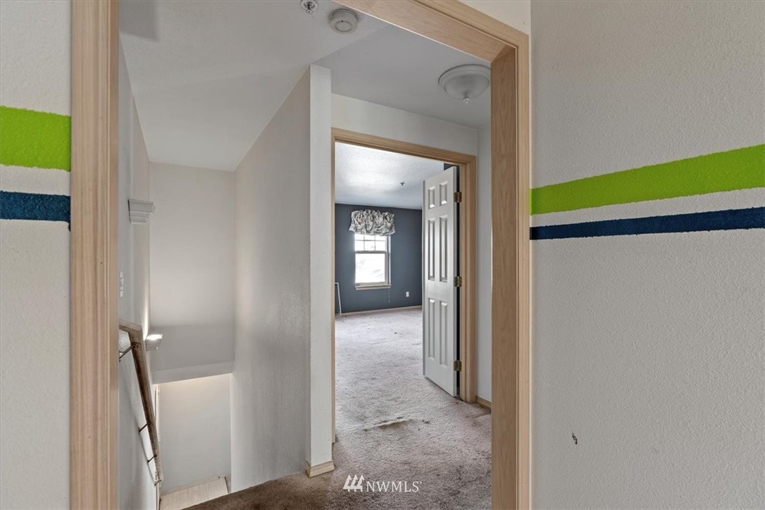 1160 Monroe Avenue Northeast, Unit B1 Renton, WA 98056 - Photo 10 of 24 a view of a hallway with a livingroom and a bathroom with a sink