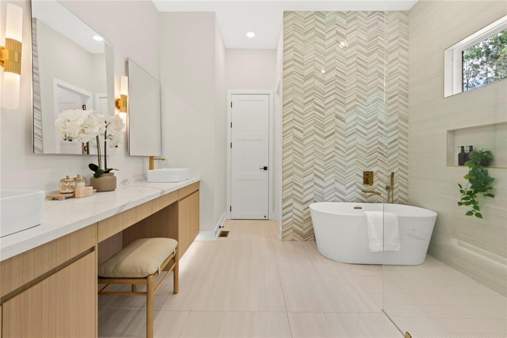 7066 Bells Way Fairburn, GA 30213 - Photo 33 of 64 a bathroom with a bathtub sink and mirror