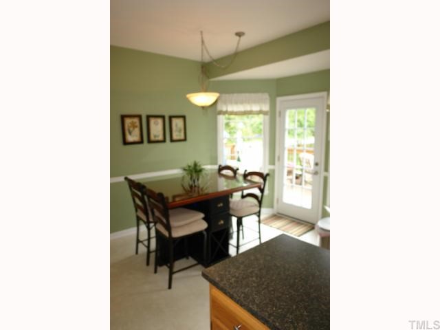 11901 Fairlie Place Raleigh, NC 27613 - Photo 3 of 12 a view of a dining room with a table and chairs