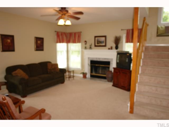 11901 Fairlie Place Raleigh, NC 27613 - Photo 4 of 12 a living room with furniture and a fireplace