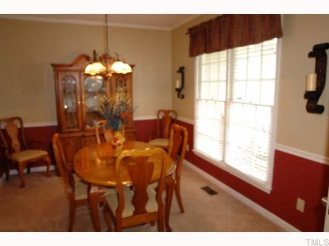 11901 Fairlie Place Raleigh, NC 27613 - Photo 5 of 12 a view of a dining room with furniture and chandelier