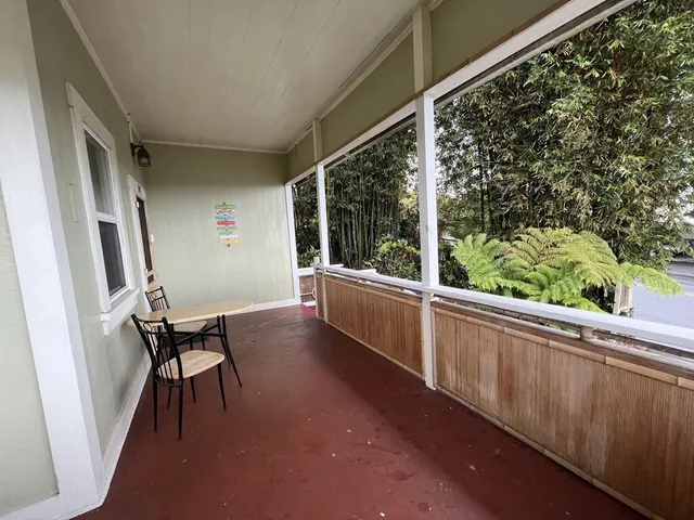 a view of a porch with furniture and next to a window