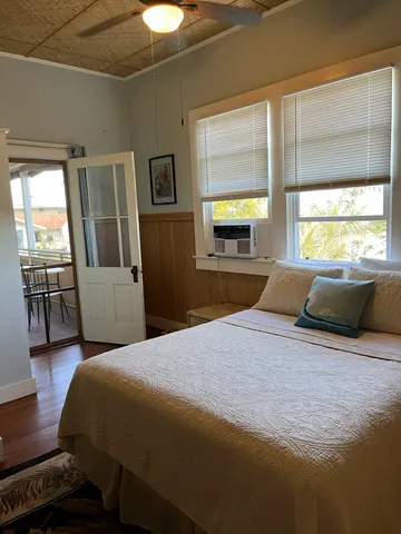 a bed room with a bed and a television