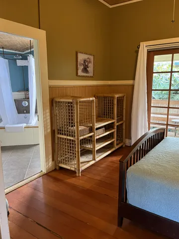 a view of bedroom with furniture and wooden floor