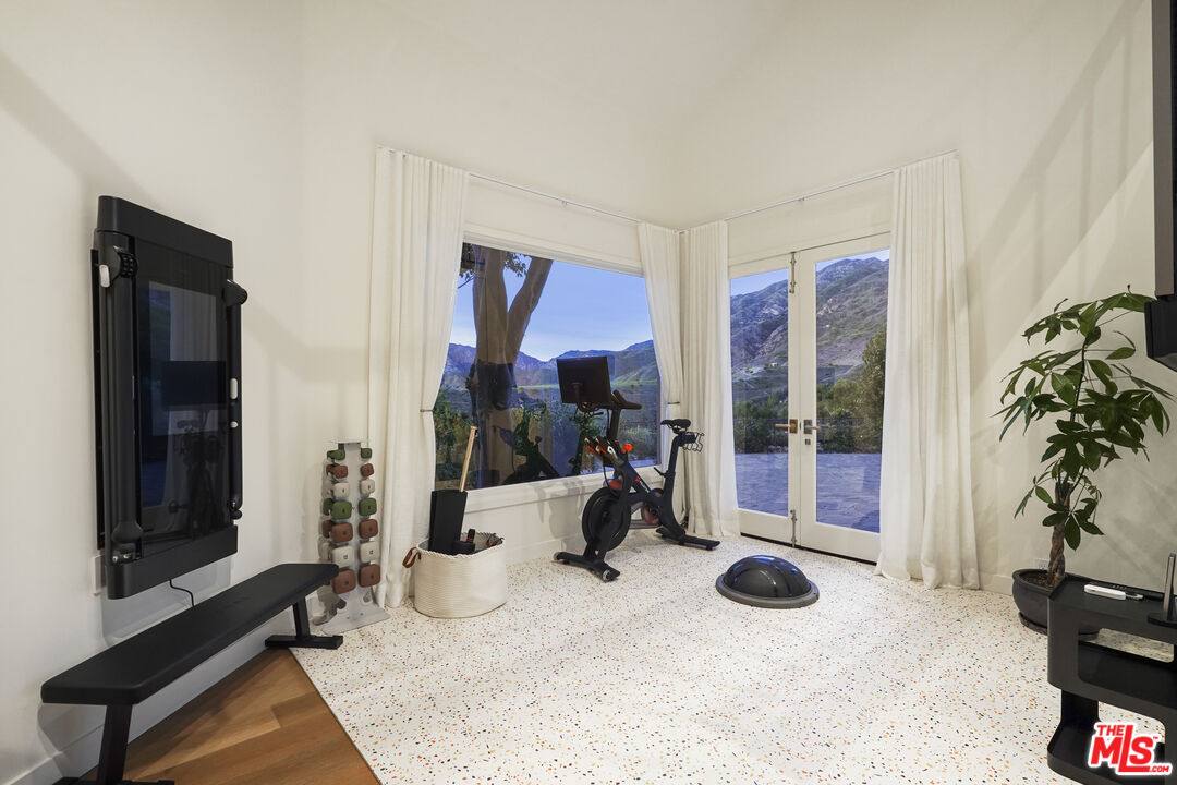 3140 Sweetwater Mesa Road Malibu, CA 90265 - Photo 53 of 71 a room with gym equipment and a large window