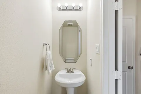 a view of a kitchen with a refrigerator and a sink
