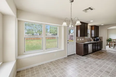 a bathroom with a granite countertop sink a large mirror and a shower