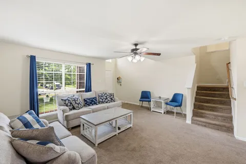 a bathroom with a granite countertop double vanity sink a large mirror and a bathtub