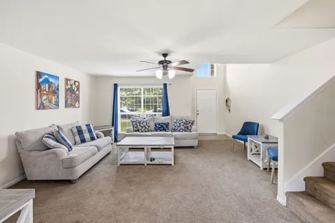 a spacious bedroom with a bed and a chandelier