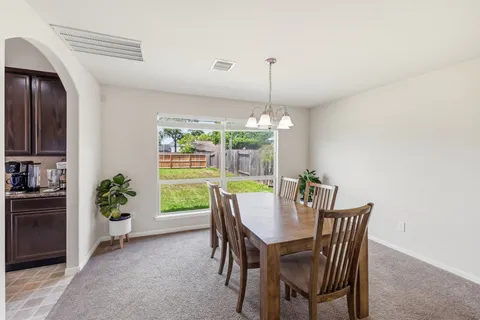 a view of a dining room with furniture window and outside view