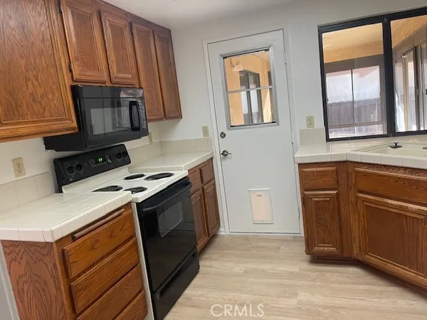 a kitchen with a stove microwave and sink