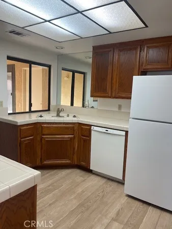 a kitchen with a sink a stove a refrigerator and a window